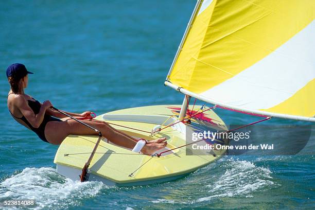 woman sailing a sunfish - sunfish stock pictures, royalty-free photos & images