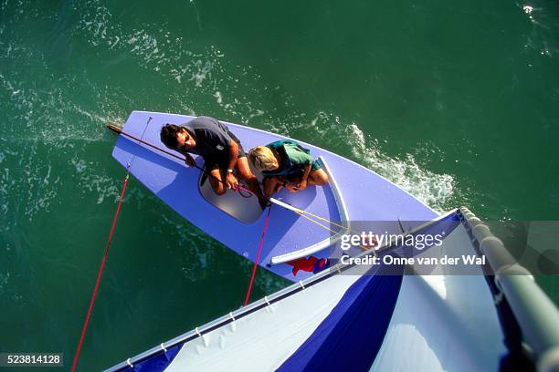 father and son sailing on a sunfish - sunfish stock pictures, royalty-free photos & images