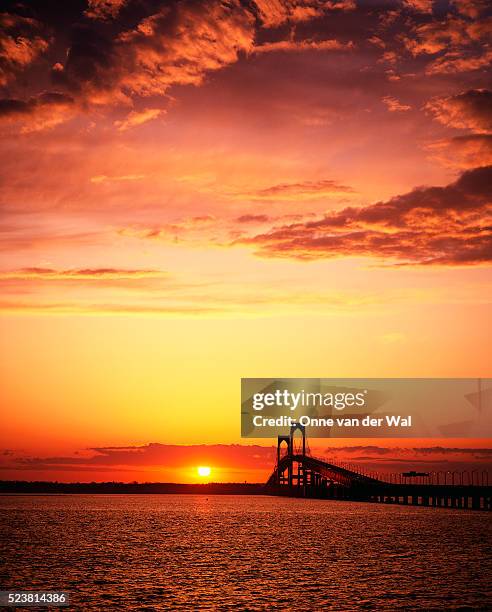 sun setting by the newport bridge - rhode island bridge stock pictures, royalty-free photos & images