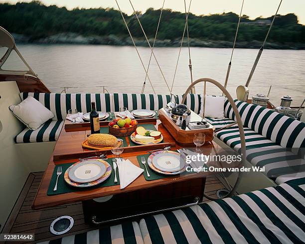 dinner table aboard the marguerite - cushion stock pictures, royalty-free photos & images