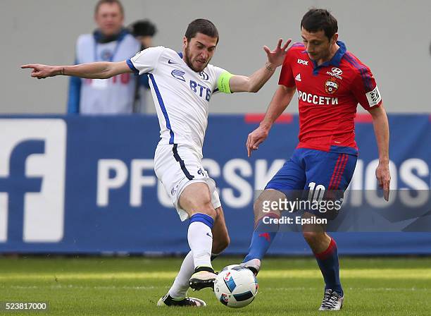 Alan Dzagoev of PFC CSKA Moscow challenged by Aleksei Ionov of FC Dinamo Moscow during the Russian Premier League match between PFC CSKA Moscow and...