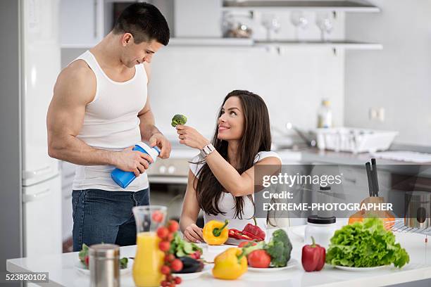 sports couple in the kitchen - extreme dieting stock pictures, royalty-free photos & images