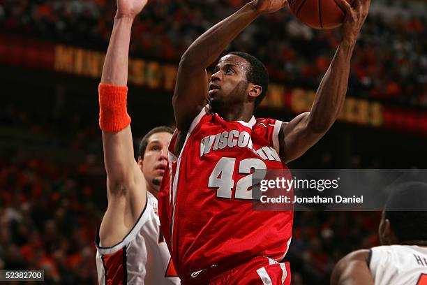 Alando Tucker of the Wisconsin Badgers drives to the basket against James Augustine of the Illinois Fighting Illini during the Final of the Big Ten...