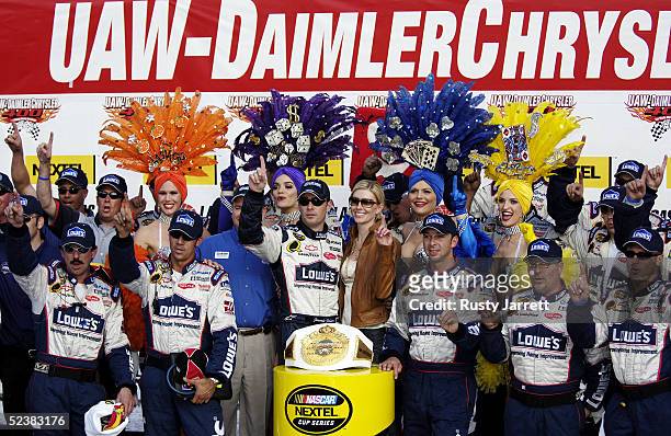 Jimmie Johnson, driver of the Hendrick Motorsports Lowe's Chevrolet celebrates with his crew after winning the NASCAR Nextel Cup UAW-DaimlerChrysler...