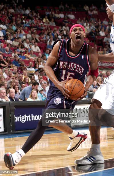 Vince Carter of the New Jersey Nets drives down the lane against the Orlando Magic during a game at TD Waterhouse Centre on March 13, 2005 in...