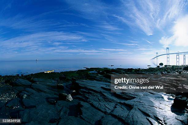 yellow kayak on rocky shore - cirrus ストックフォトと画像