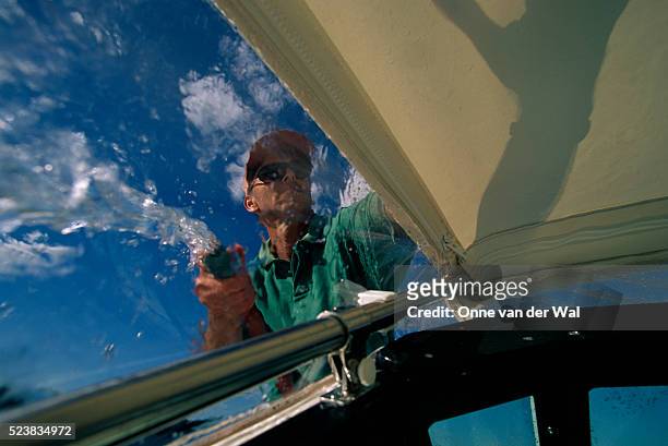 man washing boat - motorboat foto e immagini stock