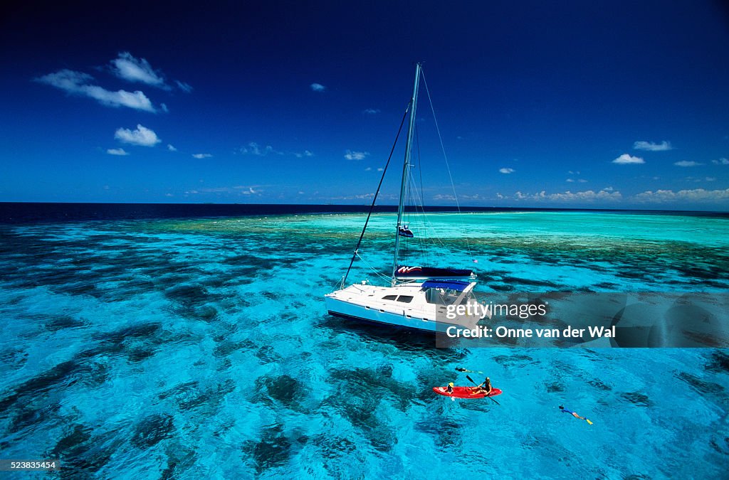 Catamaran Along a Caribbean Reef