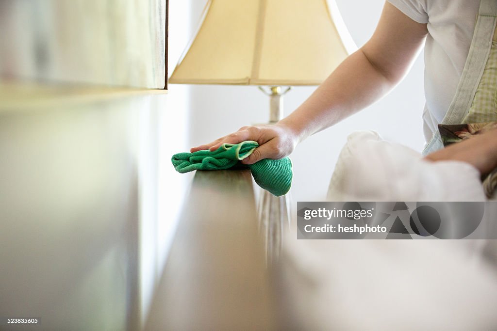 Young woman cleaning surfaces with green cleaning products