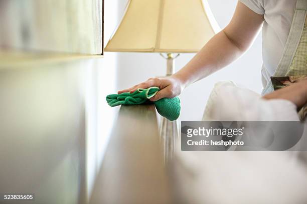 young woman cleaning surfaces with green cleaning products - dust foto e immagini stock