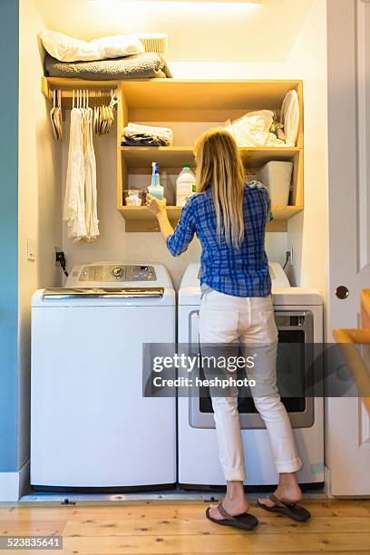 young women with green cleaning products - washing room stock pictures, royalty-free photos & images