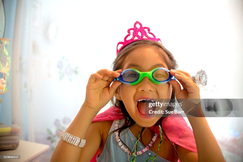 Young girl wearing fancy dress costume, pulling face