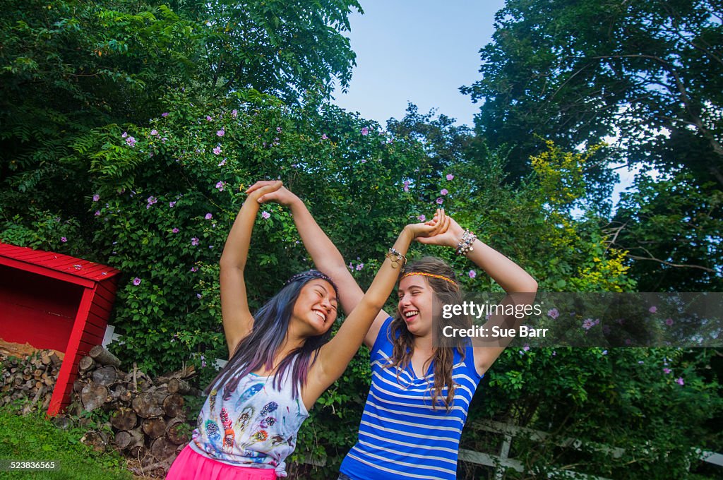 Two teenagers dancing, outdoors