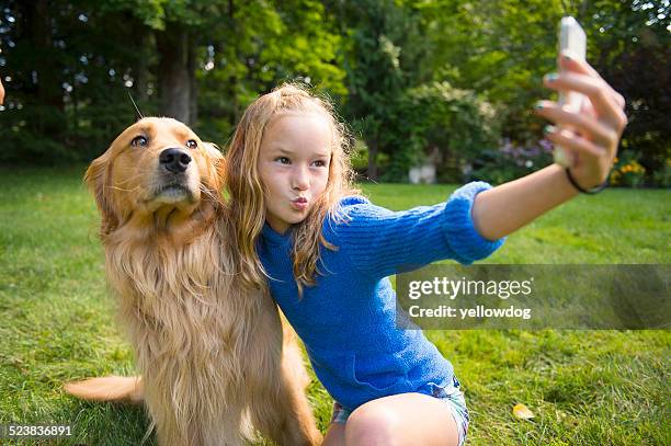 girl taking selfie with pet dog in garden - manchester vermont stock pictures, royalty-free photos & images