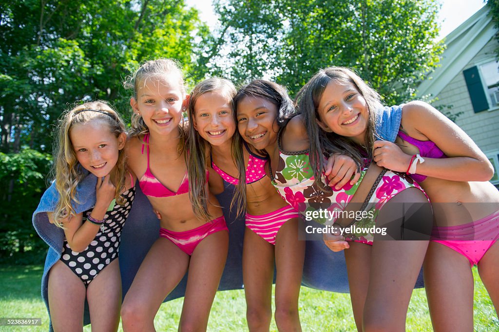 Girls in swimming costume wrapped in towel