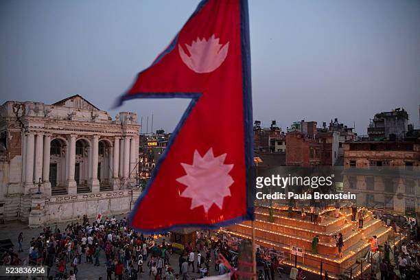 Nepali flag flutters in the wind during a candle-lighting ceremony at Durbar square for the anniversary of the Nepal earthquake April 24, 2016 in...