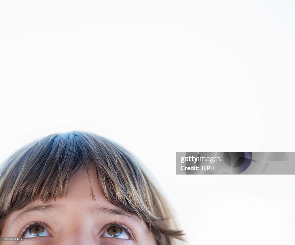 Cropped close up portrait of girl looking upward