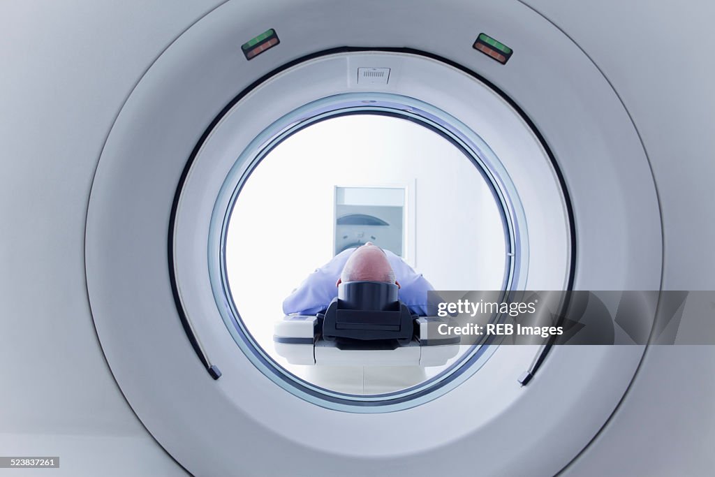 Patient lying down on CT scanner