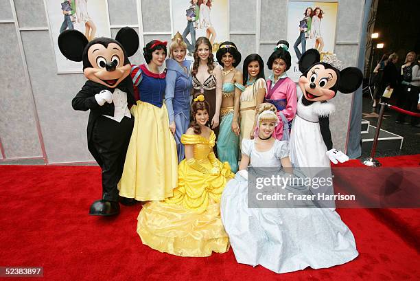 Actress Michelle Trachtenberg poses with Disney characters at the Walt Disney premiere of "The Ice Princess" at the El Capitan Theatre on March 13,...