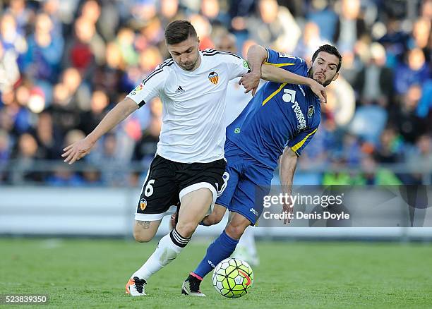 Guilherme Siqueira of Valencia CF battles for the ball against Victor Rodriguez of Getafe during the La Liga match between Getafe CF and Valencia CF...
