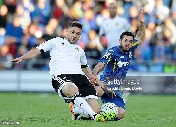 Guilherme Siqueira of Valencia CF battles for the ball against Victor Rodriguez of Getafe during the La Liga match between Getafe CF and Valencia CF...