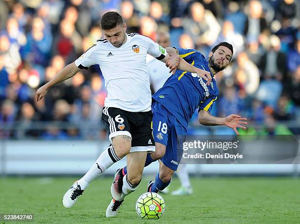 Guilherme Siqueira of Valencia CF in action against Victor Rodriguez of Getafe during the La Liga match between Getafe CF and Valencia CF at Coliseum...