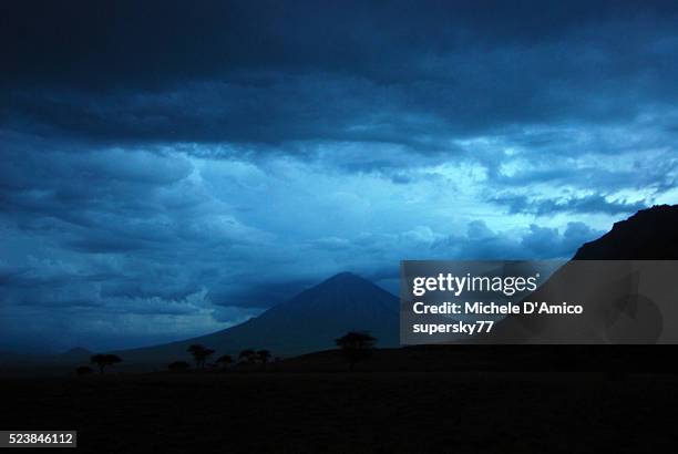 stormy clouds on a volcano. - ol doinyo lengai stock pictures, royalty-free photos & images