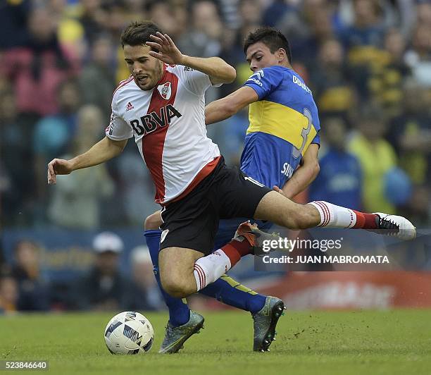 River Plate's midfielder Camilo Mayada is foulled by Boca Juniors' defender Jonathan Silva during their Argentine first division football match at...