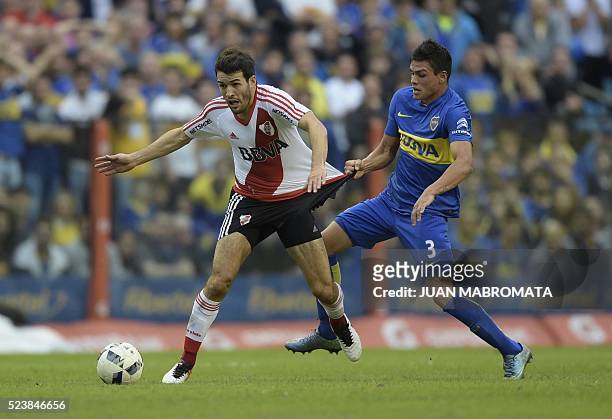 River Plate's midfielder Camilo Mayada vies for the ball with Boca Juniors' defender Jonathan Silva during their Argentine first division football...
