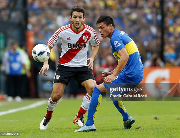 Camilo Mayada of River Plate fights for the ball with Jonathan Silva of Boca Juniors during a match between Boca Juniors and River Plate as part of...