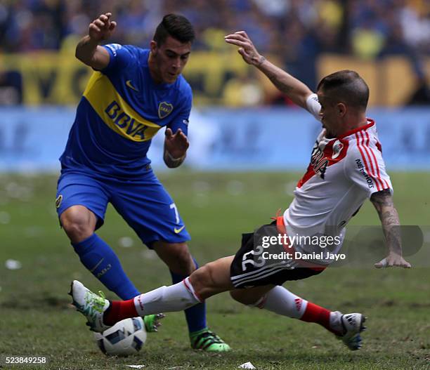 Cristian Pavon of Boca Juniors and Andres D'Alessandro of River Plate vie for the ball during a match between Boca Juniors and River Plate as part of...