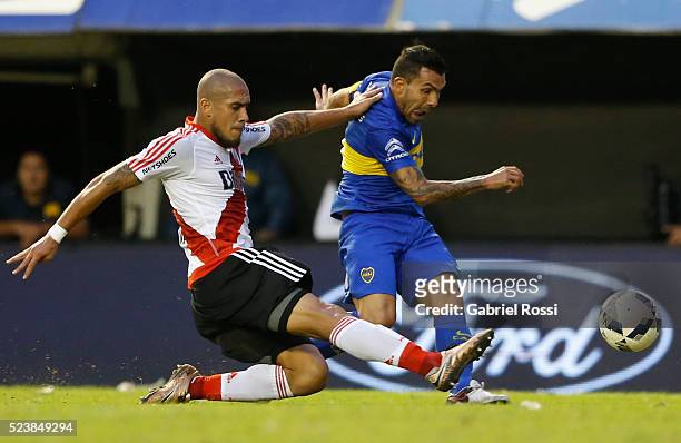 Carlos Tevez of Boca Juniors fights for the ball with Jonathan Maidana of River Plate during a match between Boca Juniors and River Plate as part of...