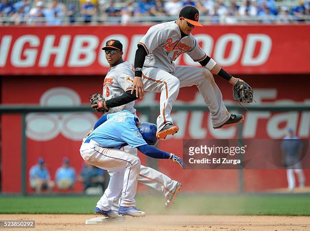 Manny Machado of the Baltimore Orioles leaps over Jarrod Dyson of the Kansas City Royals as he gets the force out in the eighth inning at Kauffman...