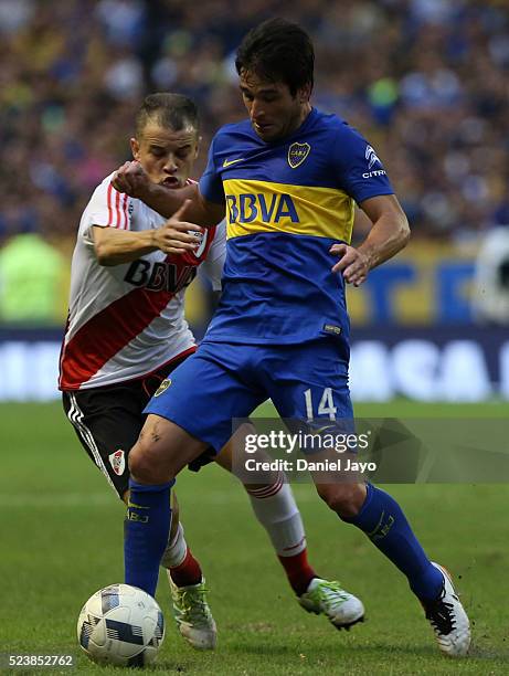 Nicolas Lodeiro of Boca Juniors dribbles past Andres D'Alessandro of River Plate during a match between Boca Juniors and River Plate as part of...