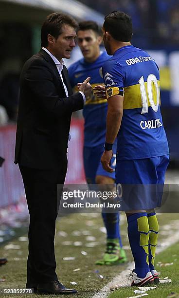 Guillermo Barros Schelotto coach of Boca Juniors speaks to Carlos Tevez of Boca Juniors during a match between Boca Juniors and River Plate as part...