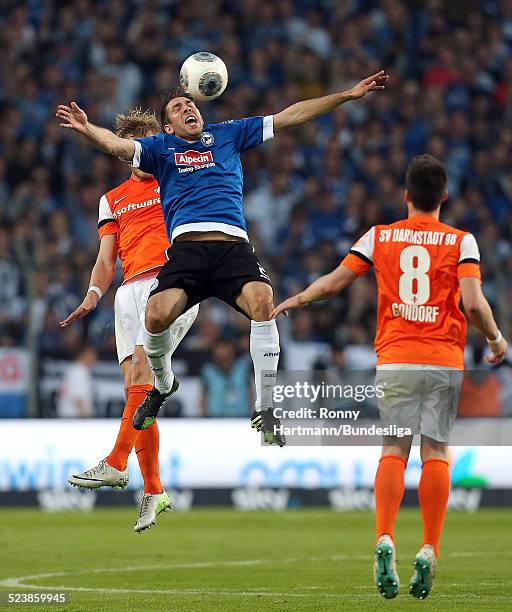 Patrick Schoenfeld of Bielefeld competes with Hanno Behrens and Jerome Gondorf of Darmstadt during the Second Bundesliga Playoff Second Leg match...