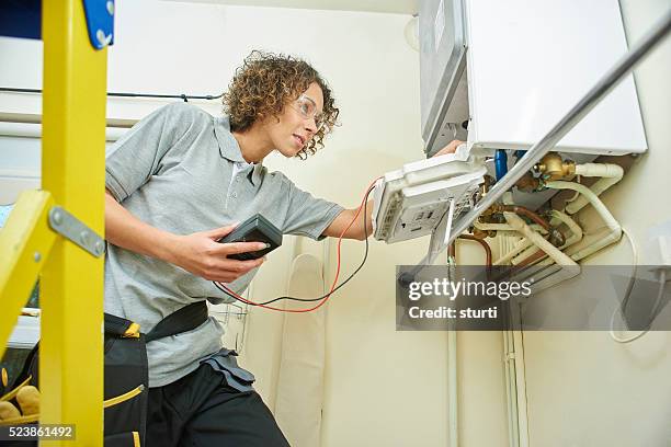 female plumber - installing ceiling light fixture stock pictures, royalty-free photos & images