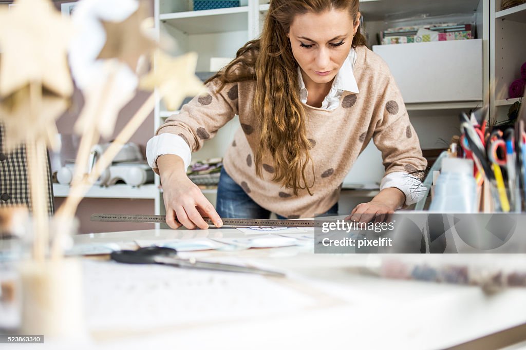 Artisan woman working with paper