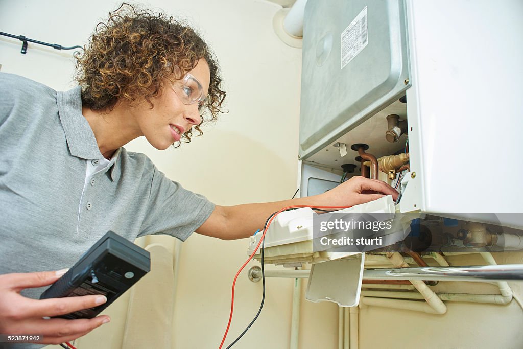 Female plumber with central heating