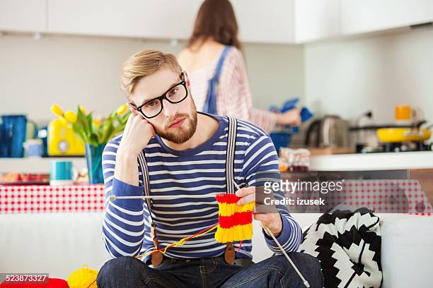 young man knitting - man knitting stock pictures, royalty-free photos & images