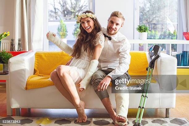 young people with broken leg and arms - man touching womans leg stock pictures, royalty-free photos & images