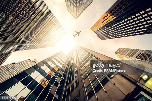 skyscraper with a airplane silhouette - abstract plane stock pictures, royalty-free photos & images