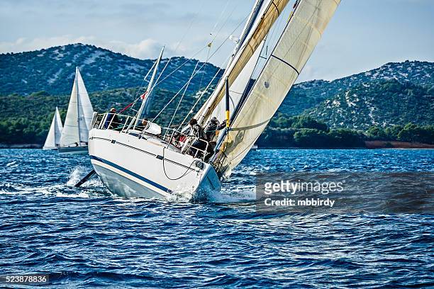 sailing crew on sailboat during regatta - race unity stock pictures, royalty-free photos & images