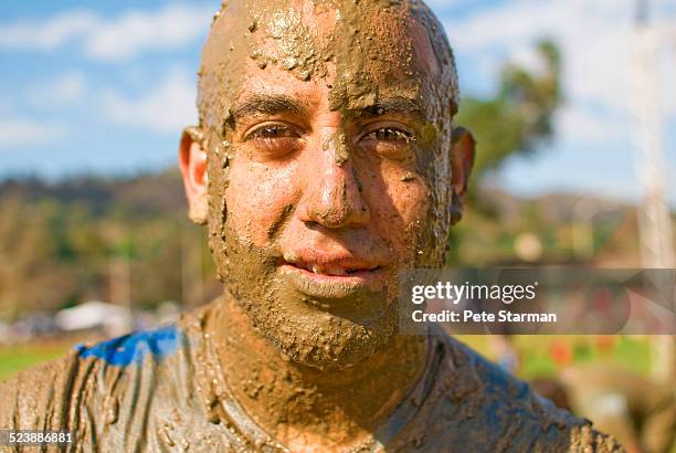 5k competitor covered in mud. - people covered in mud stock pictures, royalty-free photos & images