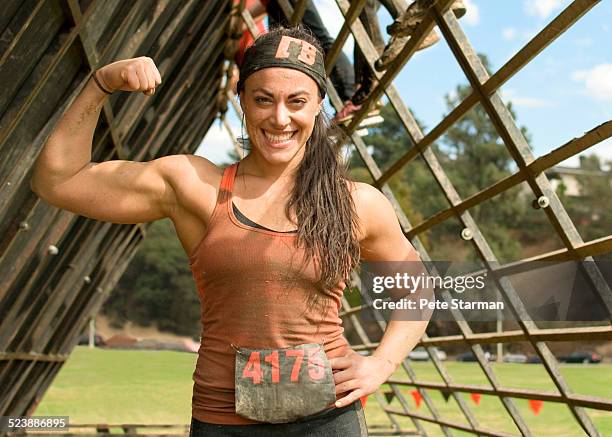 5K Hispanic female competitor flexing bicep.