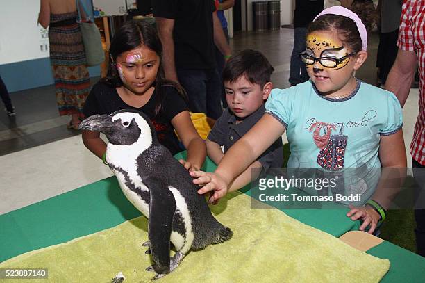 Children with a baby penguin at Safe Kids Day 2016 presented by Nationwide at Smashbox Studios on April 24, 2016 in Los Angeles, California.