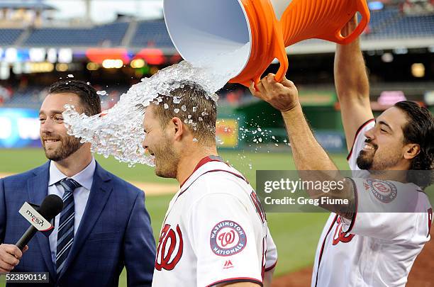 Chris Heisey of the Washington Nationals is doused with water by Anthony Rendon after hitting the game-winning home run in the 16th inning against...