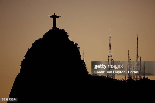 The iconic Cristo Redentor, Christ the Redeemer statue at sunset with communication antenna atop the mountain Corcovado shot from Suger Loaf...