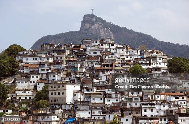 View from Santa Teresa in the hills of Rio de Janeiro as The iconic Cristo Redentor, Christ the Redeemer statue sits atop the mountain Corcovado. In...