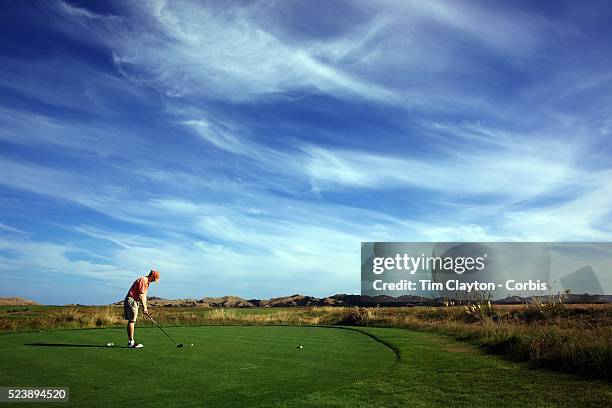 Golfers at Cape Kidnappers exclusive golf course. Hawkes Bay, North Island, New Zealand..Completed in 2004 and designed by legendary golf architect...